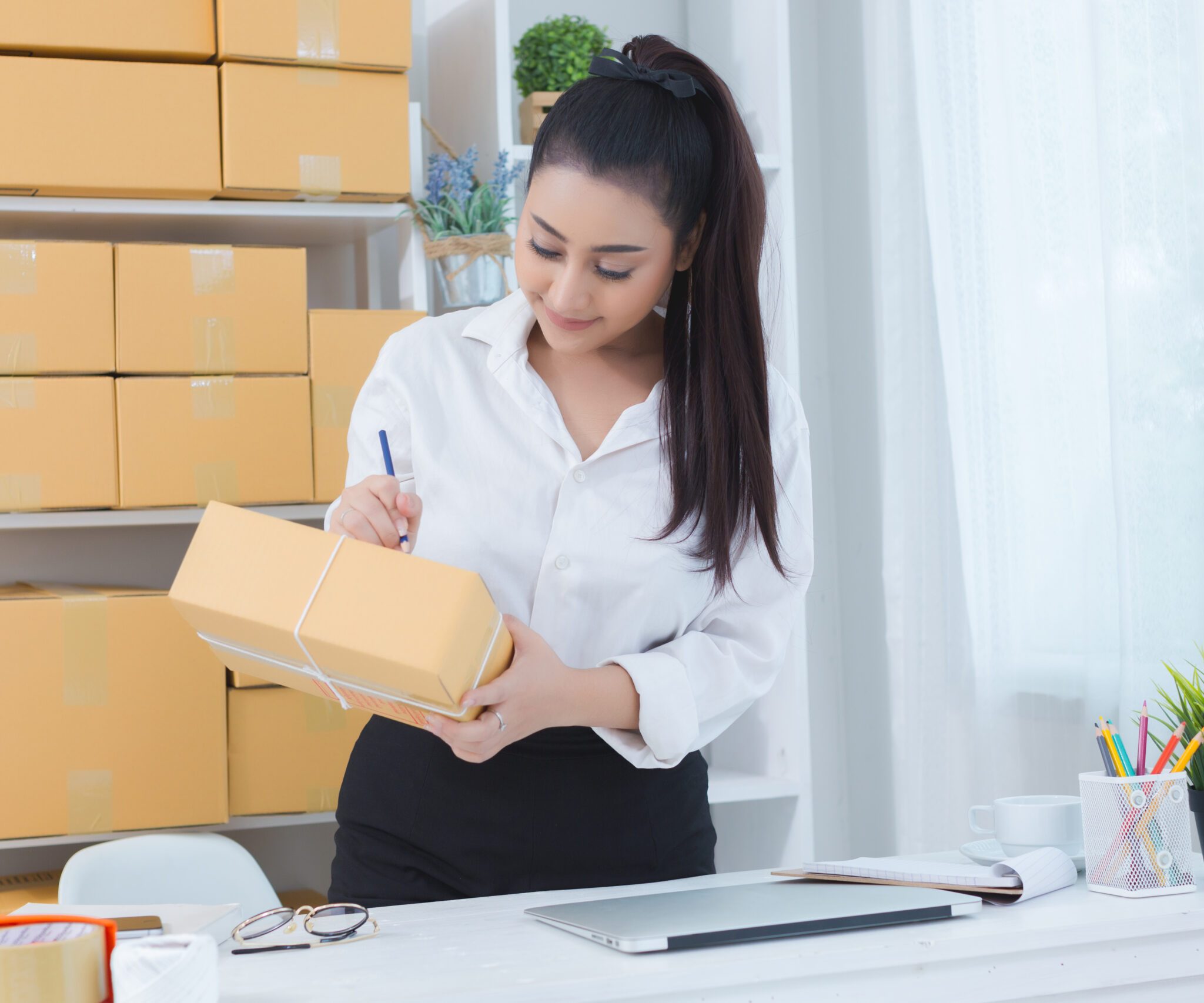 business owner working at home office packaging on background. online shopping SME entrepreneur working Young Women happy after new order from customer.